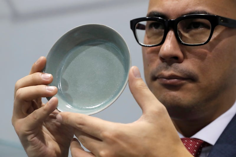 Nicolas Chow presents the extremely rare Ru Guanyao brush washer from China's Northern Song Dynasty at the Sotheby's Hong Kong Chinese Works of Art Autumn Sales in Hong Kong. Kin Cheung / AP Photo