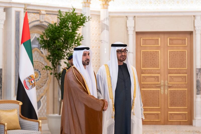 President Sheikh Mohamed stands for a photograph with Ibrahim Al Alawi, ambassador to Peru