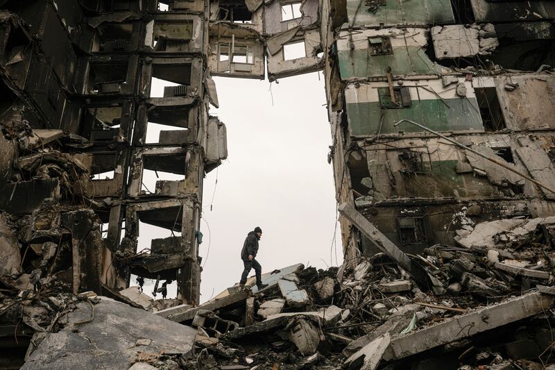 A resident looks for belongings in an apartment building destroyed during fighting between Ukrainian and Russian forces in Borodyanka, Ukraine, Tuesday, April 5, 2022.  (AP Photo / Vadim Ghirda)