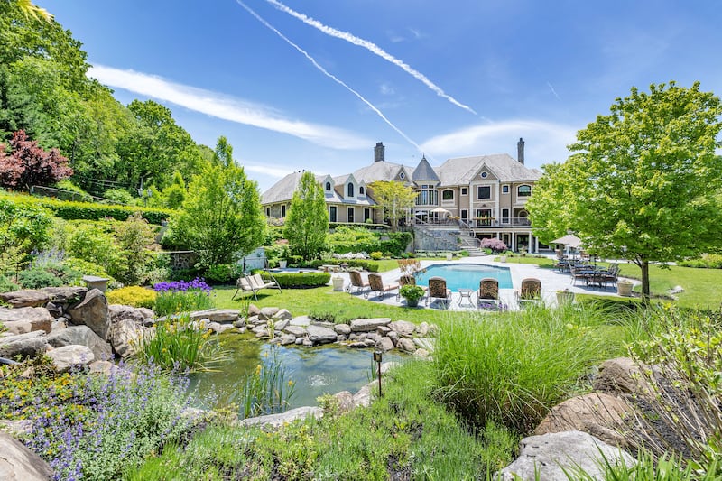 The estate has a heated, saltwater pool and koi pond. Courtesy Douglas Elliman Realty