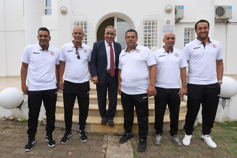 The new coach of the Tunisian national football team Faouzi Benzarti poses with his staff  in front of the federation headquarters in Tunis. AFP