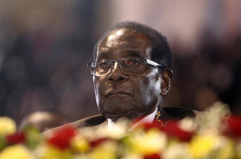 FILE - In this April 7,  2016 file photo Zimbabwean President Robert Mugabe attends a meeting with the country's war veterans in Harare.  Mugabe seemed almost untouchable for much of his nearly four-decade rule. Shrewd and ruthless, he managed to stay in power despite advancing age, growing opposition, international sanctions and the dissolving economy of a once-prosperous African nation. Now, the apparent abrupt end of the Mugabe era is launching Zimbabwe into the unknown. It's a humbling close to the career of a man who crushed dissent or sidelined opponents after leading Zimbabwe since 1980. (AP Photo/Tsvangirayi Mukwazhi, File)