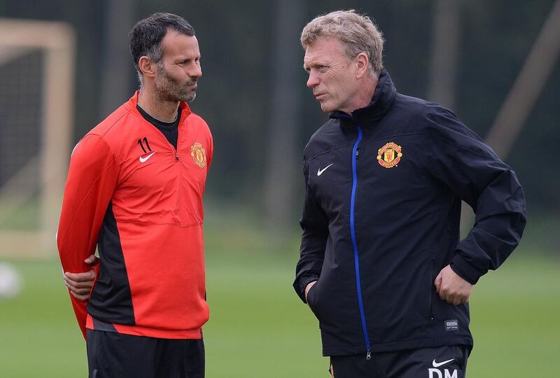 Former Manchester United manager David Moyes, right, speaks to Manchester United's Welsh midfielder Ryan Giggs during a training session at the team's Carrington training complex in Manchester, north-west England on April 22, 2014. Andrew Yates / AFP

