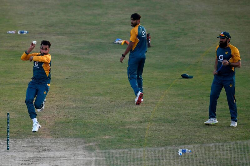 Pakistan's Faheem Ashraf bowls as coach Misbah-ul-Haq and teammate Haris Rauf watch during a practice session at the Rawalpindi Cricket Stadium ahead of their first Twenty20 against Zimbabwe. AFP