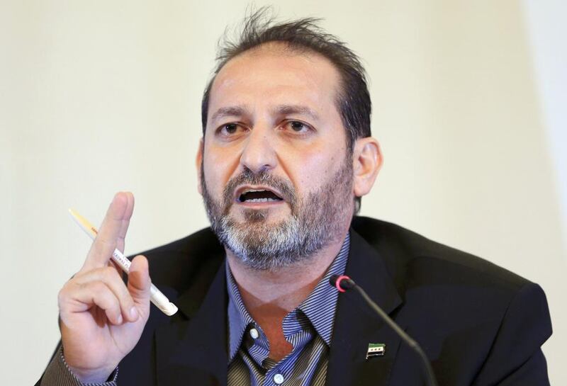 Fateh Hassoun, a member of the Syrian High Negotiations Committee opposition group, addresses the media in Geneva (Pierre Albouy / Reuters)