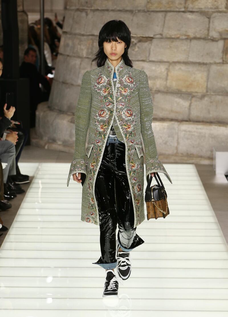 Louis Vuitton teams a brocade top coat with PVC trousers. Courtesy Louis Vuitton