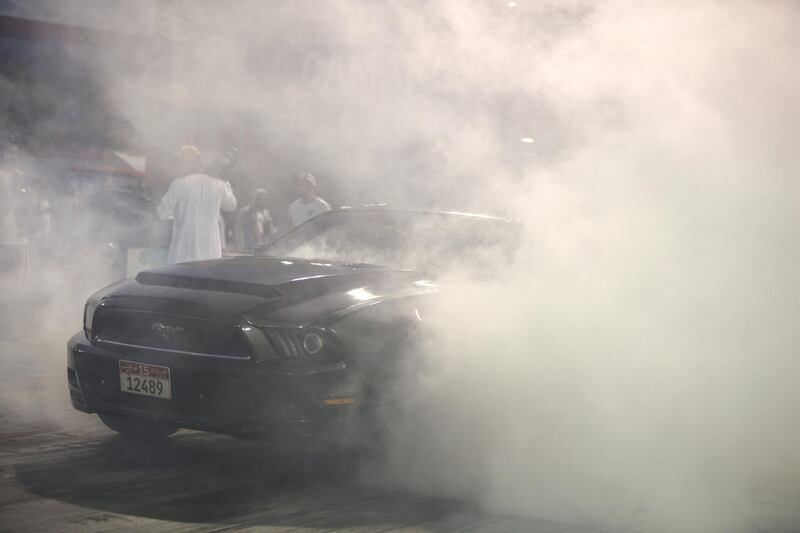 Abu Dhabi, United Arab Emirates - Mustangs burn out before the race, at the Drag Race Car Show event sponsored by Premium Motors & organized by Emirates Mustang Club at Yas Marina Circuit on January 29, 2018. (Khushnum Bhandari/ The National)