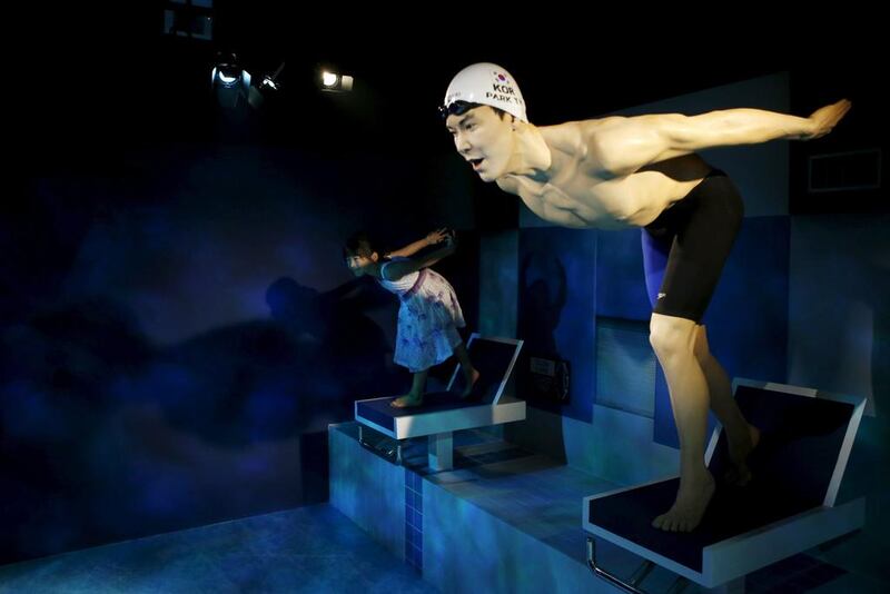 A girl gets ready  to compete with the wax figure of South Korea’s Olympic swimming champion Park Tae-hwan at Grevin Wax Museum in Seoul, South Korea, on July 30, 2015. Kim Hong-Ji / Retuers