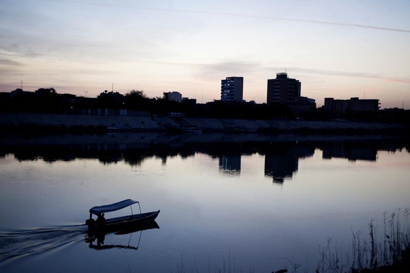 BAGHDAD, IRAQ - MARCH 29:  A fisherman drives his motorboat on the Tigris river at dawn on March 29, 2013 in Baghdad, Iraq.  Ten years after the regime of Saddam Hussein was toppled from power, Baghdad continues to show the scars of the war. In vast areas, infrastructure is fractured and basic services are lacking, however, some areas of the capital are showing promising signs of recovery. (Photo by Ali Arkady/Metrography/Getty Images)