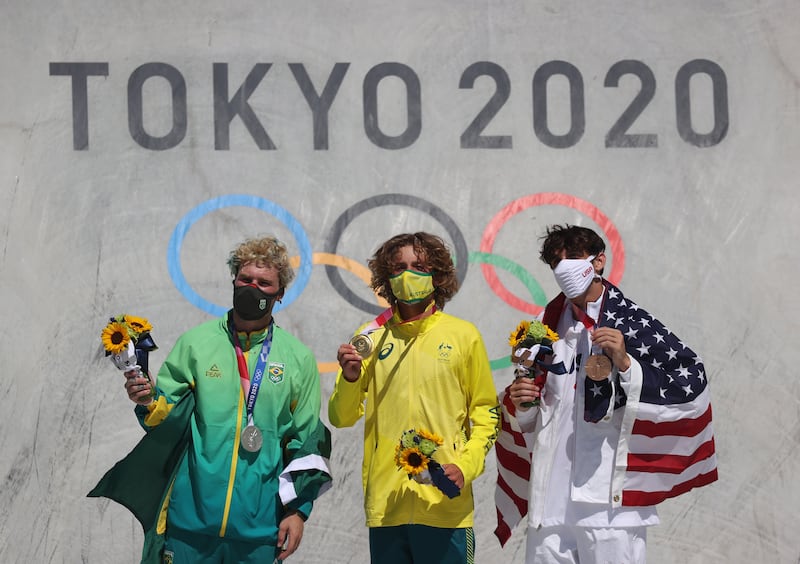 Silver medalist Pedro Barros of Brazil, gold medalist Keegan Palmer of Australia and bronze medalist Cory Juneau of the USA show their medals during the Men's Park Skateboarding Finals awarding ceremony.
