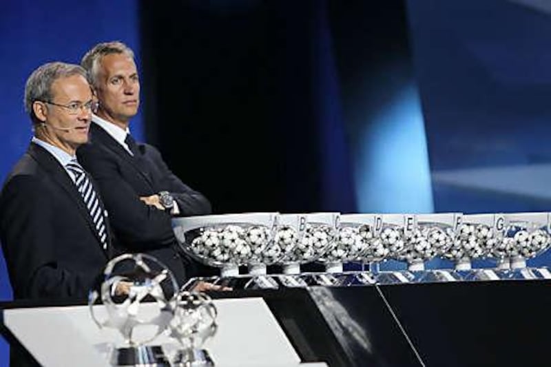 Uefa's competitions director Giorgio Marchetti, left, and former England striker Gary Lineker stand on stage during the draw in Monaco.