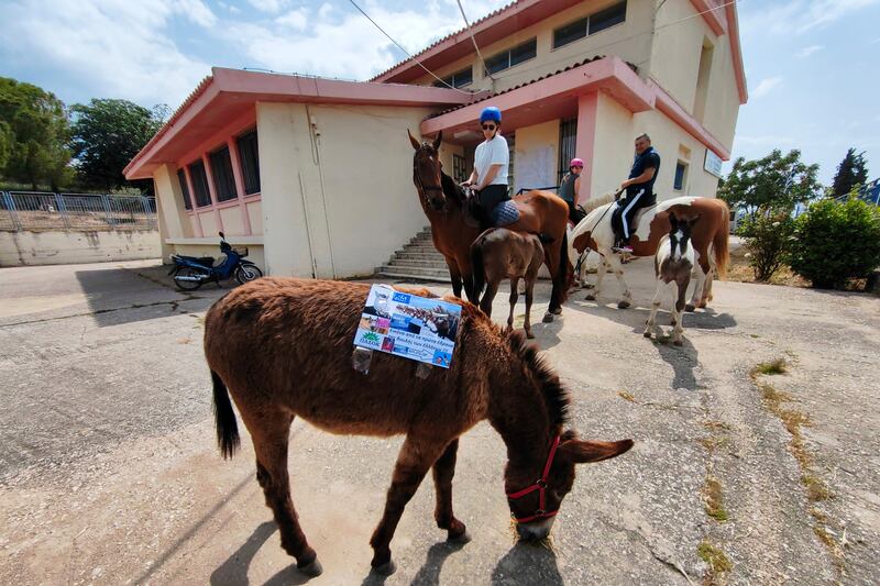 Citizens arrive on horseback to vote at a general election polling station in Nafplio, Greece. EPA