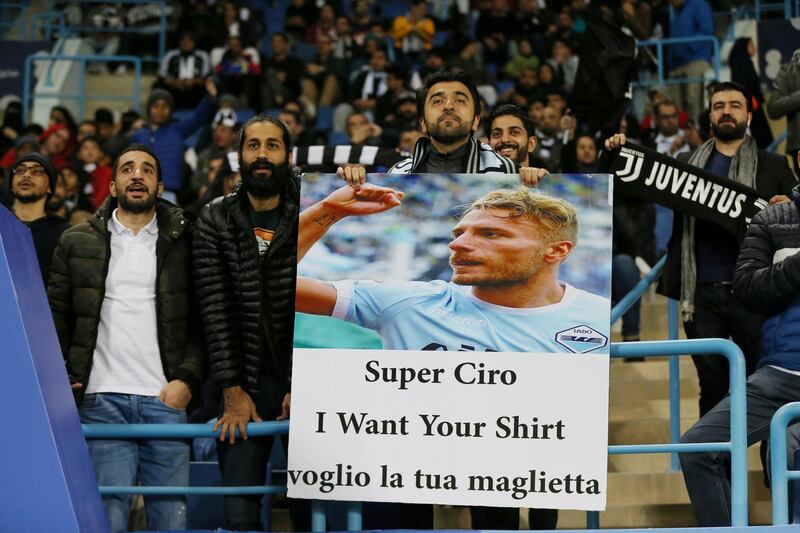 A Lazio fan holds up a sign for Lazio's Ciro Immobile before the match. Reuters