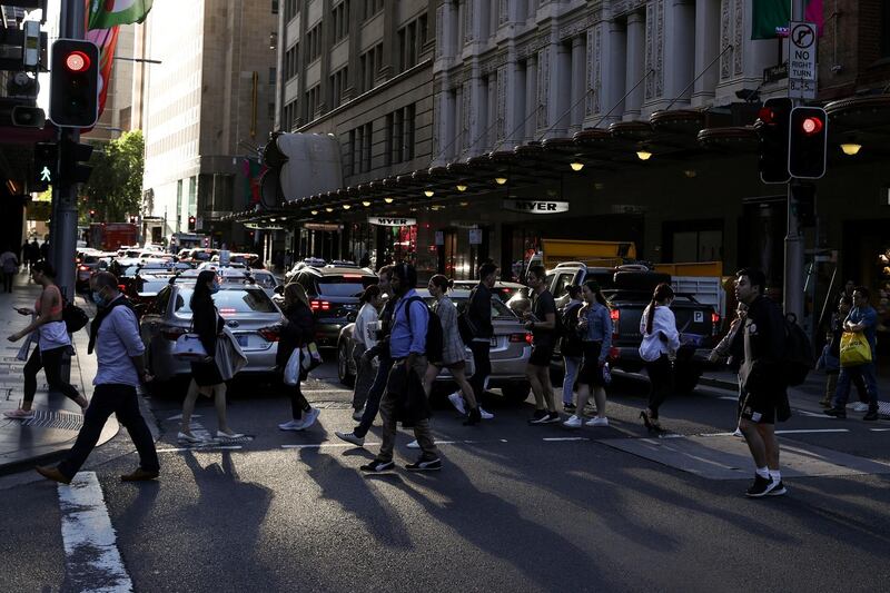 People walk through a congested intersection in the city centre of Sydney, Australia, November 9, 2020.  REUTERS/Loren Elliott