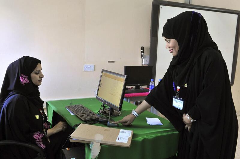 A woman has her fingerprint scanned before voting at a polling station in Muscat during Oman’s last shura council election on October 15, 2011. Said Al Bahri / Reuters