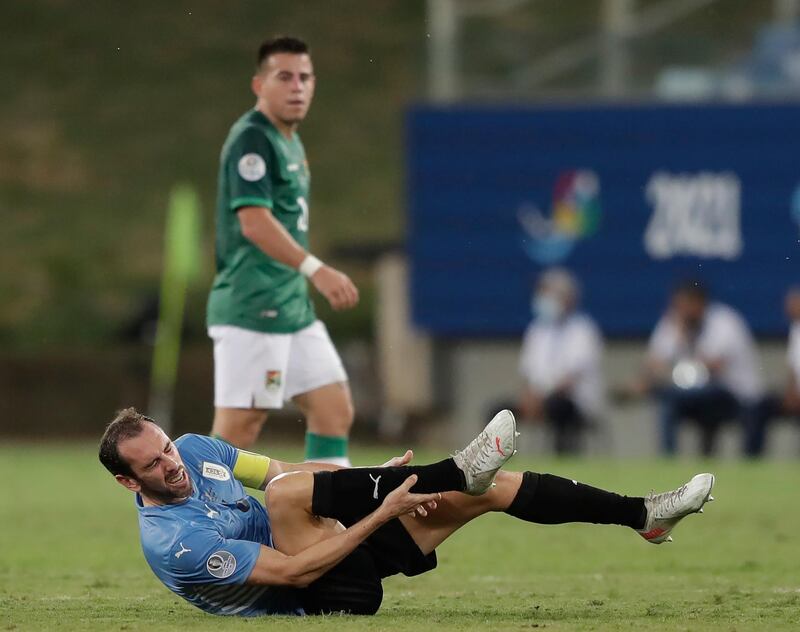 Uruguay defender Diego Godin grimaces in pain after being fouled against Bolivia. AP