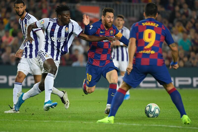 Barcelona's Argentine forward Lionel Messi vies with Valladolid's Ghanaian defender Mohammed Salisu (second left) during a league match between Barcelona and Real Valladolid at the Camp Nou / AFP / LLUIS GENE