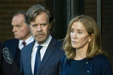 Actress Felicity Huffman, escorted by her husband William H. Macy, exits the John Joseph Moakley United States Courthouse in Boston, where she was sentenced for her role in the College Admissions scandal. AFP