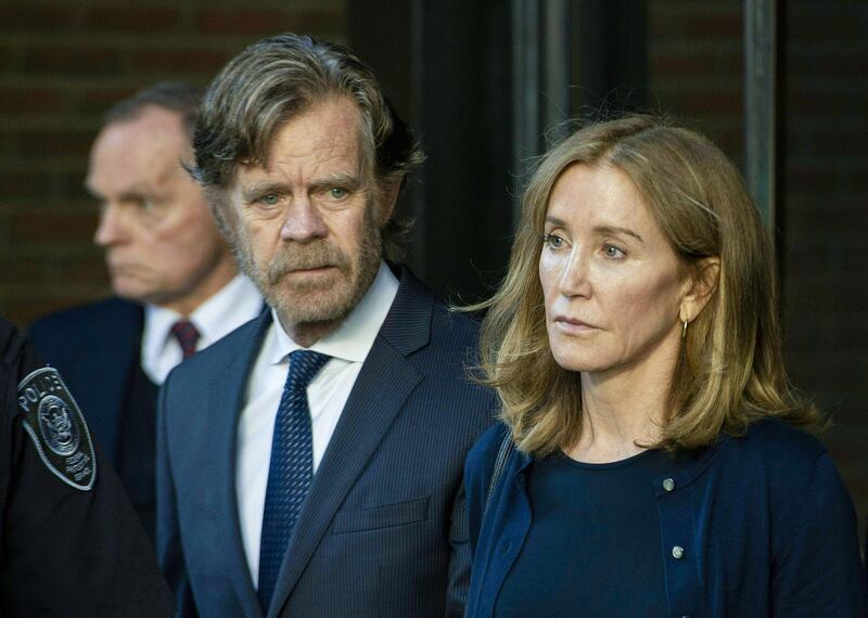 Actress Felicity Huffman, escorted by her husband William H. Macy, exits the John Joseph Moakley United States Courthouse in Boston, where she was sentenced by Judge Talwani for her role in the College Admissions scandal on September 13, 2019. Actress Felicity Huffman gets 14 days jail in US college admissions scandal / AFP / Joseph Prezioso
