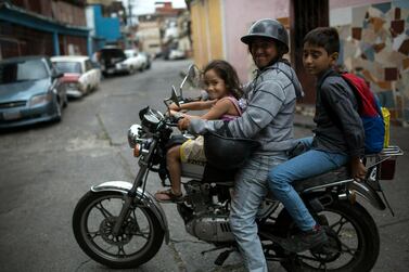 Venezuelans pose in Caracas. AP