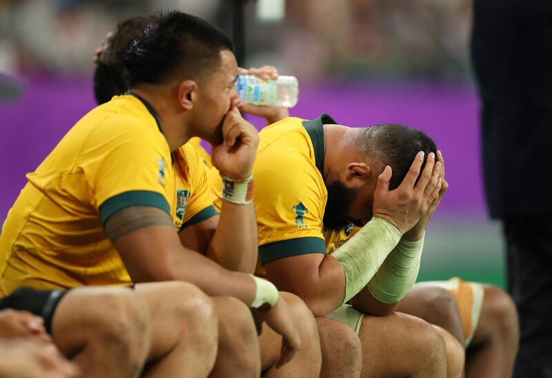 Tolu Latu of Australia looks dejected on the bench with team mates during the Rugby World Cup 2019 Quarter Final match between England and Australia at Oita Stadium in Oita, Japan. Getty Images