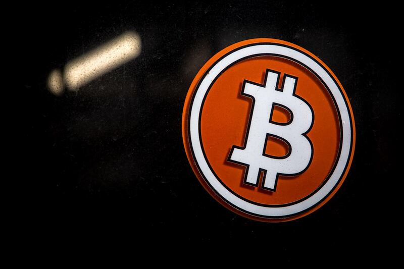 A bitcoin logo in the window of a bitcoin automated teller machine (ATM) kiosk in Barcelona, Spain, on Tuesday, Feb. 23, 2021. Bitcoin climbed, aided by supportive comments from Ark Investment Management’s Cathie Wood and news that Square Inc. boosted its stake in the cryptocurrency. Photographer: Angel Garcia/Bloomberg