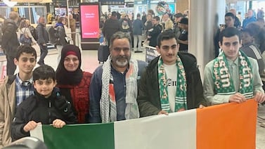 Zak Hania (centre) and his wife Batoul and their four children after being reunited at Dublin Airport. PA