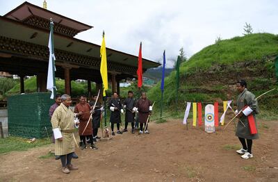 In this photo taken on August 25, 2018, president of the Bhutan Indigenous Games and Sports Association (BIGSA), Kinzang Dorji (L), interacts with archers during a practice tournament at the Changlimithang Archery Ground in Thimphu. The traditional sport is a way of life for some 800,000 people in the small Himalayan kingdom of Bhutan. - TO GO WITH Bhutan-archery-lifestyle,FEATURE by Abhaya Srivastava
 / AFP / ARUN SANKAR / TO GO WITH Bhutan-archery-lifestyle,FEATURE by Abhaya Srivastava
