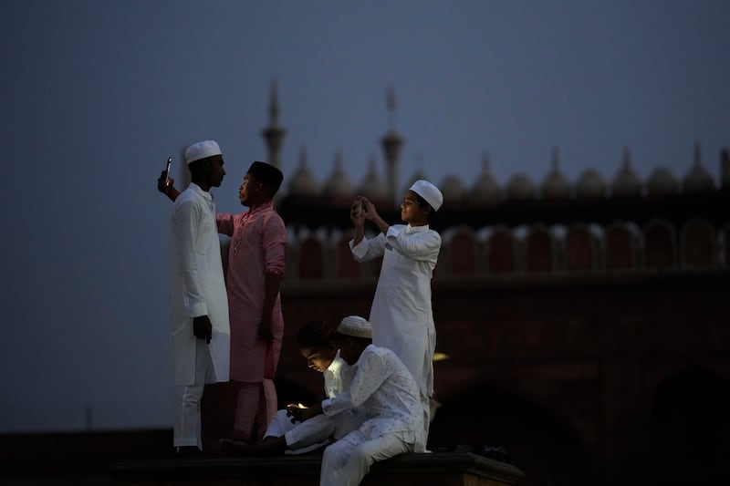 Muslims take selfies in New Delhi. AP