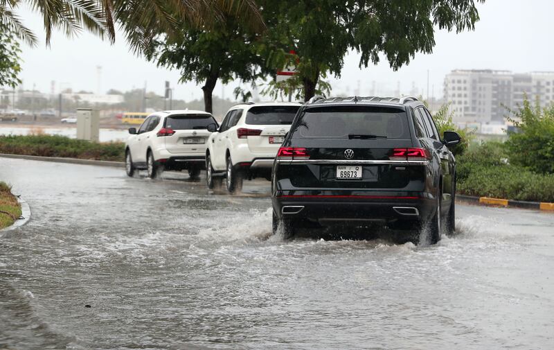 Vehicles navigate a flooded road around the Al Furjan area in Dubai. Pawan Singh / The National 