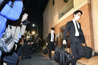 Officials from the Tokyo District Public Prosecutors Office carry bags after raiding the Tokyo residence of former Nissan chairman Carlos Ghosn. Kyodo via Reuters  