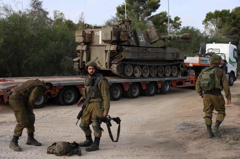 Israeli troops unload 155 mm artillery at an undisclosed location on the border with the Gaza Strip. AFP