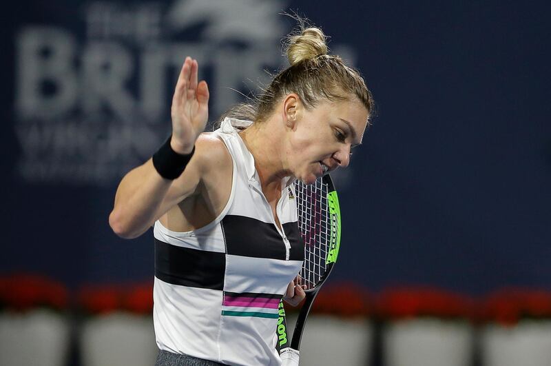 Simona Halep, of Romania, reacts after missing a shot to Karolina Pliskova, of the Czech Republic, during a semifinal in the Miami Open tennis tournament Thursday, March 28, 2019, in Miami Gardens, Fla. (AP Photo/Joe Skipper)