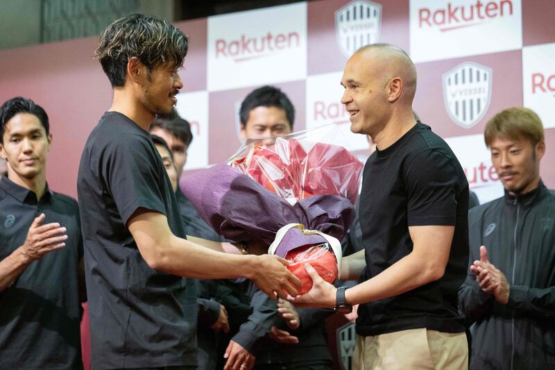 Andres Iniesta is presented flowers by teammates at the end of a press conference to announce his exit from Vissel Kobe. AFP