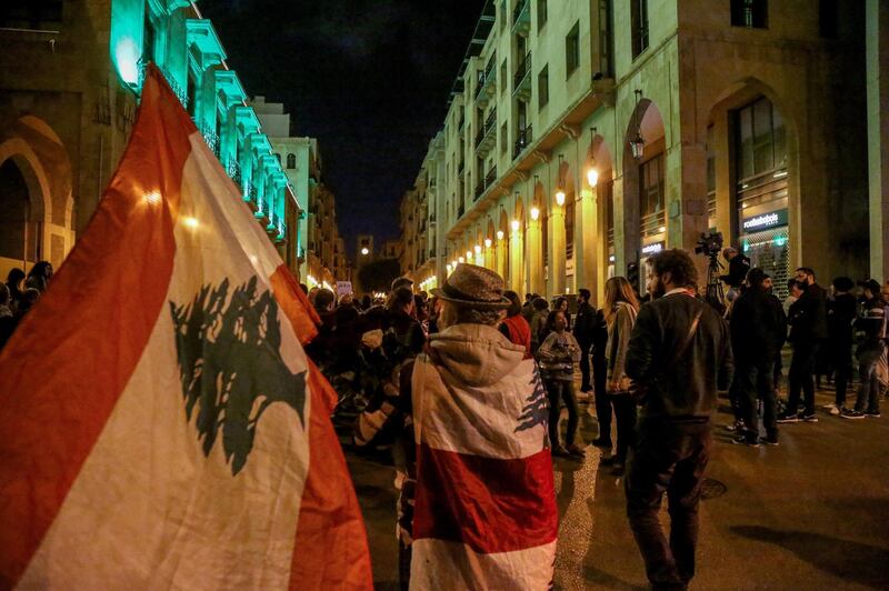 Lebanese anti-government protesters carry candles and national flags as they march against the incitement of sectarian strife, and for the freedom of religious expression on the 63rd day of Lebanon's nationwide anti-government. EPA