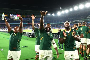 Mbongeni Mbonambi of South Africa (L) celebrates with Tendai Mtawarira (C) and captain Siya Kolisi after the World Cup semi-final victory over Wales. Getty