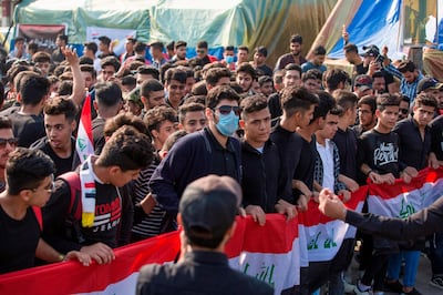 Students take part in a march to mourn protesters killed in anti-government rallies in the southern Iraqi city of Basra on December 1, 2019. Demonstrators have hit the streets since early October in Baghdad and the Shiite-majority south to demand the ouster of a government they accuse of being corrupt, inefficient and beholden to foreign powers. After a spike in deaths this week raised the toll to more than 420 killed, Prime Minister Adel Abdel Mahdi said Friday he would submit his resignation to parliament. The chamber was due to convene later Sunday, but no agenda had yet been published. / AFP / Hussein FALEH
