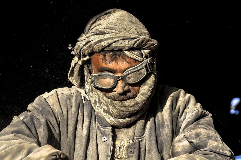 An Afghan labourer works at a plastic recycle factory in Herat, Afghanistan.  Afghanistan's economy has improved, with the help of international aid, after suffering decades of fighting. JALIL REZAYEE / EPA