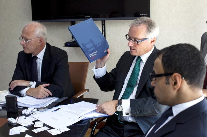 Richard Williams, centre, BLME's chief financial officer, answers a journalist's question, as Humphrey Percy, left, the chief executive, and Waleed Al Omar, the head of investor relations, listen during a roundtable at the company's office in Dubai. Christopher Pike / The National