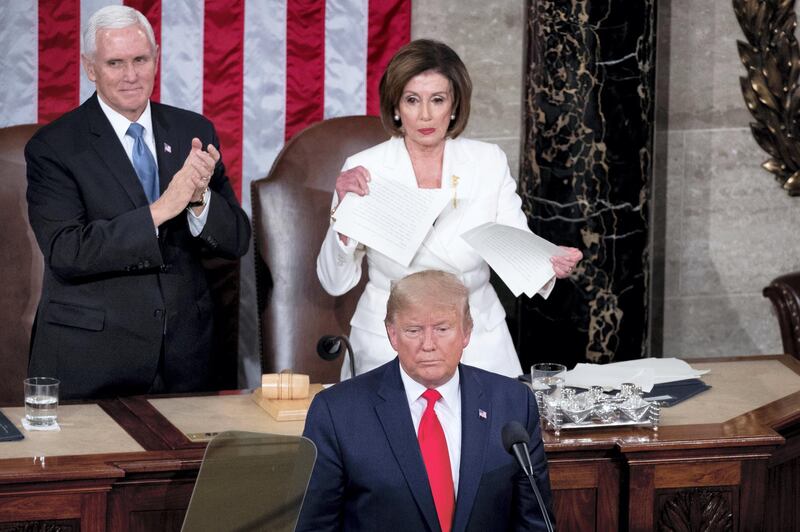 epa08939632 (FILE) Speaker of the House Nancy Pelosi (C, top) tears up a copy of the State of the Union address that US President Donald J. Trump (C, bottom) just delivered, as US Vice President Mike Pence (L) looks on, in front of the floor of the US House of Representatives on Capitol Hill in Washington, DC, USA, 04 February 2020. The presidency of Donald Trump, which records two presidential impeachments, will end at noon on 20 January 2021.  EPA-EFE/MICHAEL REYNOLDS *** Local Caption *** 56621646