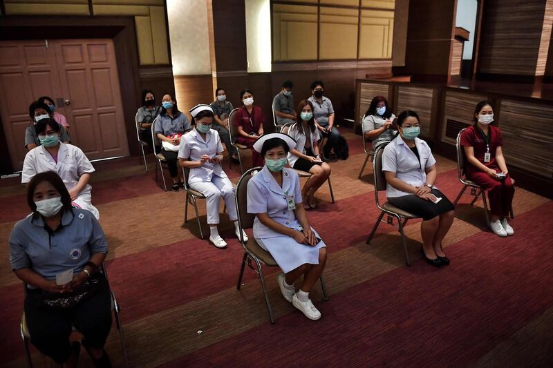 Health workers wait to receive the CoronaVac vaccine, developed by China’s Sinovac firm, as the first batch of vaccines are administered to frontline health workers at the Bamrasnaradura Infectious Diseases Institute in Bangkok. EPA