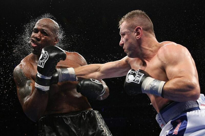 Tomasz Adamek, right, of Poland, lands a punch on Travis Walker during the fifth round of a heavyweight boxing match at the Prudential Center in Newark, N.J., Saturday, Sept. 8, 2012. Adamek won by TKO in five rounds. (AP Photo/Tim Larsen)