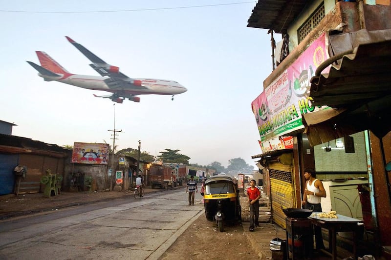 An Air India passenger jet flies into Mumbai Airport. Daniel Berehaluk / Getty