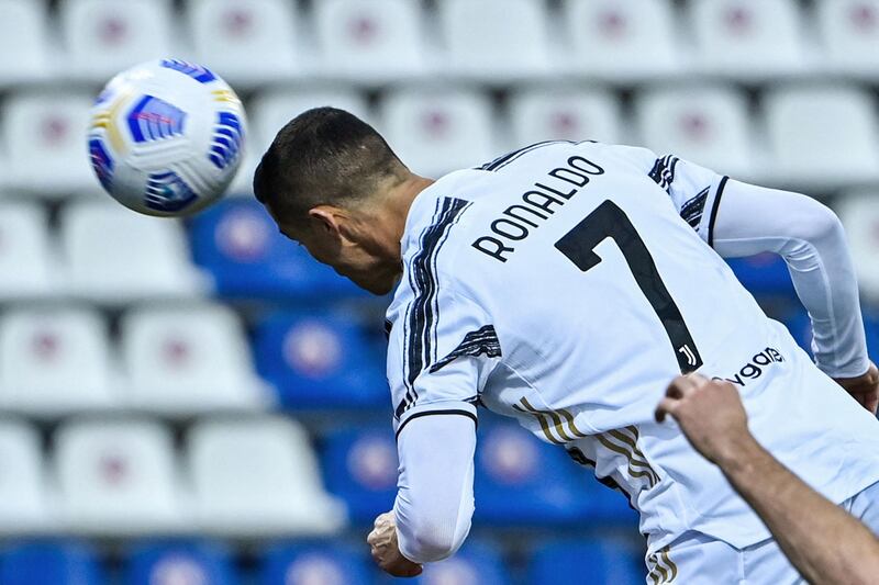 Cristiano Ronaldo heads the ball to open the scoring for Juventus during the Serie A match at Cagliari on a record-breaking night. AFP