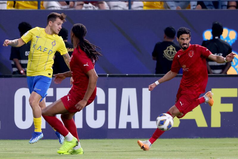 Al Nassr midfielder Otavio in action against Al Duhail defenders Ruben Semedo and Sultan Al Brake. AFP