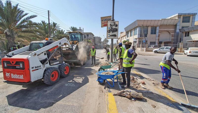 Municipal workers fix a road  in Libya's Tajura area, a coastal suburb east of the capital. AFP