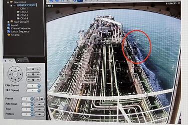 CCTV footage of the Hankuk Chemi, a South Korean-flagged oil tanker, is displayed on a screen as a boat of Iran's Revolutionary Guards is seen in red circle on the screen. AFP