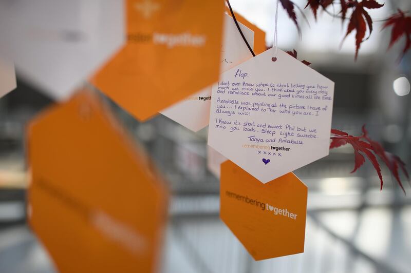A hand-written message is seen on one of the 'Trees of Hope" placed throughout the city. Getty