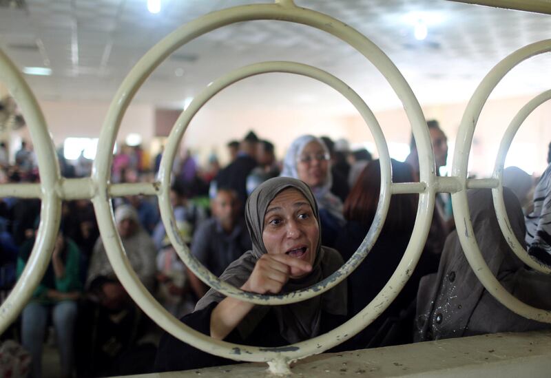 A Palestinian woman gestures as she asks for a travel permit to cross into Egypt through the Rafah border crossing after it was opened by Egyptian authorities for humanitarian cases, in Rafah in the southern Gaza Strip August 16, 2017. Ibraheem Abu Mustafa / Reuters