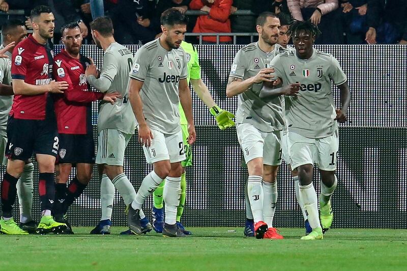 Juventus' Moise Kean, right, stands by teammate Leonardo Bonucci as he celebrates after scoring his side's second goal during a Serie A soccer match between Cagliari and Juventus at the Sardegna Arena Stadium in Cagliari, Italy, Tuesday, April 2, 2019. Cagliari fans shouted racist chants at Kean after the 19-year-old scored in the 85th minute, the chants were so bad that Cagliari captain Luca Ceppitelli rushed in to protect the youngster and ask the fans to stop. (Fabio Murru/ANSA via AP)